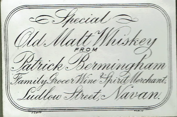 Engraved label reading Special Old Malt Whiskey from Patrick Bermingham, Family Grocer, Wine & Spirit Merchant, Ludlow Street, Navan